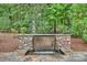 Serene water feature with stone wall and lush greenery at 13824 Claysparrow Rd, Charlotte, NC 28278