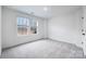 An empty bedroom with gray carpet, white walls, and two windows at 1609 Blanche St, Charlotte, NC 28262