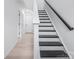 Modern staircase featuring black treads, white risers, and a black handrail at 1609 Blanche St, Charlotte, NC 28262