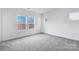 Bright bedroom with carpet, white walls, and natural light from multiple windows at 1617 Blanche St, Charlotte, NC 28262