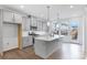 Well-lit kitchen features island with sink, stainless appliances, gray cabinets and modern pendant lighting at 1617 Blanche St, Charlotte, NC 28262