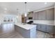 Bright kitchen features gray cabinets, a large island, stainless appliances and modern pendant lighting at 1617 Blanche St, Charlotte, NC 28262