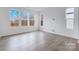 Sun-filled living room featuring hardwood floors and three large windows offering natural light at 1617 Blanche St, Charlotte, NC 28262