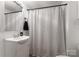 Clean bathroom with a shower/tub combo and black and white striped curtain at 217 Burrage Ne Rd, Concord, NC 28025