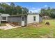 Detached garage with white and gray siding, single door, and window at 217 Burrage Ne Rd, Concord, NC 28025