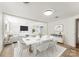 Bright dining room features a white table with seating for six and an open concept layout at 217 Burrage Ne Rd, Concord, NC 28025