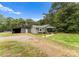 House exterior with a detached shed and gravel driveway at 217 Burrage Ne Rd, Concord, NC 28025