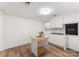 White kitchen with light wood floors and kitchen island at 217 Burrage Ne Rd, Concord, NC 28025