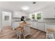 Bright kitchen with white cabinets, and a kitchen island with seating at 217 Burrage Ne Rd, Concord, NC 28025