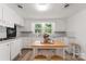 White kitchen with updated appliances and wood-look flooring at 217 Burrage Ne Rd, Concord, NC 28025