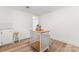 White kitchen with light wood floors and kitchen island at 217 Burrage Ne Rd, Concord, NC 28025