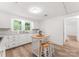 Bright eat-in kitchen with white cabinets, wood countertops, and kitchen island at 217 Burrage Ne Rd, Concord, NC 28025