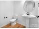 Elegant bathroom featuring a pedestal sink and sleek fixtures, offering minimalist charm at 5735 Allburn Pkwy, Concord, NC 28027