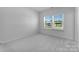 Bright bedroom with large window and plush carpeting offers a serene living space at 5735 Allburn Pkwy, Concord, NC 28027