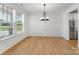 Bright dining area featuring hardwood floors, large windows and elegant lighting at 5735 Allburn Pkwy, Concord, NC 28027