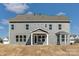 Back exterior of a two-story gray house with an open yard under a bright blue sky at 5735 Allburn Pkwy, Concord, NC 28027