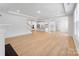Spacious living room flowing into kitchen with white cabinets and large island at 5735 Allburn Pkwy, Concord, NC 28027
