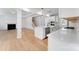Open-concept kitchen and living room with white trim and flooring at 5735 Allburn Pkwy, Concord, NC 28027