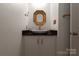 Modern powder room with a white vessel sink and gold accents at 11770 Redbridge Blvd, Locust, NC 28097