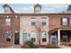 Brick front of charming townhome with teal and blue doors at 11770 Redbridge Blvd, Locust, NC 28097