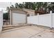 Detached garage with white roll-up door and adjacent fence at 11770 Redbridge Blvd, Locust, NC 28097