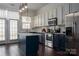 Modern kitchen boasts dark blue cabinetry, quartz countertops, and stainless steel appliances at 11770 Redbridge Blvd, Locust, NC 28097