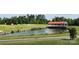 Landscaped pond and quaint covered bridge at 11770 Redbridge Blvd, Locust, NC 28097