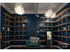 Built-in shelving with teal accent chair creates a stylish home office at 11770 Redbridge Blvd, Locust, NC 28097