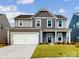 Two-story house with gray siding, white garage door, and landscaping at 2074 Van Buren Rd, Sherrills Ford, NC 28673