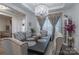 Elegant dining room featuring a large table, chandelier, and gray upholstered chairs at 13050 Regent Grove Ln, Huntersville, NC 28078