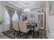 Formal dining room with a dark wood table, chandelier, and neutral decor at 13050 Regent Grove Ln, Huntersville, NC 28078