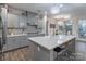 Modern kitchen with gray cabinets, large island, and stainless steel appliances at 13050 Regent Grove Ln, Huntersville, NC 28078