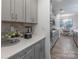 Modern kitchen with gray cabinets, quartz countertops, and stainless steel appliances at 13050 Regent Grove Ln, Huntersville, NC 28078