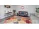 Cozy living room with a gray sofa and colorful area rug at 13050 Regent Grove Ln, Huntersville, NC 28078