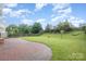 Brick patio and fenced backyard with a small wooden bridge at 11434 Lamoille Ln, Charlotte, NC 28278