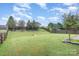 Landscaped backyard with wooden fence and small bridge at 11434 Lamoille Ln, Charlotte, NC 28278