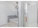 Bathroom with soaking tub, shower, and chandelier at 11434 Lamoille Ln, Charlotte, NC 28278