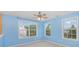 Light blue bedroom with three windows and ceiling fan at 11434 Lamoille Ln, Charlotte, NC 28278