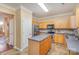 Kitchen with island, stainless steel appliances, and wood cabinets at 11434 Lamoille Ln, Charlotte, NC 28278