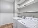 Laundry room with washer, dryer, and overhead shelving at 11434 Lamoille Ln, Charlotte, NC 28278