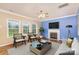 Living room with fireplace, hardwood floors, and access to the kitchen at 11434 Lamoille Ln, Charlotte, NC 28278