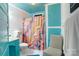 Retro bathroom with teal accents and colorful shower curtain at 317 Kerr Nw St, Concord, NC 28025