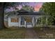 Charming white house with a porch and well-manicured lawn at 317 Kerr Nw St, Concord, NC 28025