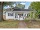 White house with a porch and walkway, nice yard at 317 Kerr Nw St, Concord, NC 28025