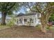 White house with a front porch, partially obscured by trees at 317 Kerr Nw St, Concord, NC 28025