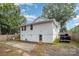 Rear view of a single story house with a large backyard and a paved patio area at 317 Kerr Nw St, Concord, NC 28025