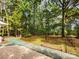 Backyard features a fenced in area, grass, and many trees at 331 Sunderland Rd, Belmont, NC 28012