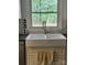 Close-up of farmhouse sink and gooseneck faucet under window with natural light at 331 Sunderland Rd, Belmont, NC 28012