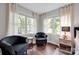 Comfortable sitting area in the bedroom features two navy chairs and two windows that let in plenty of light at 470 Lakeview Shores Loop, Mooresville, NC 28117