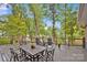 Spacious deck with outdoor dining set, offering serene views of the lake and surrounding trees, ideal for entertaining at 470 Lakeview Shores Loop, Mooresville, NC 28117